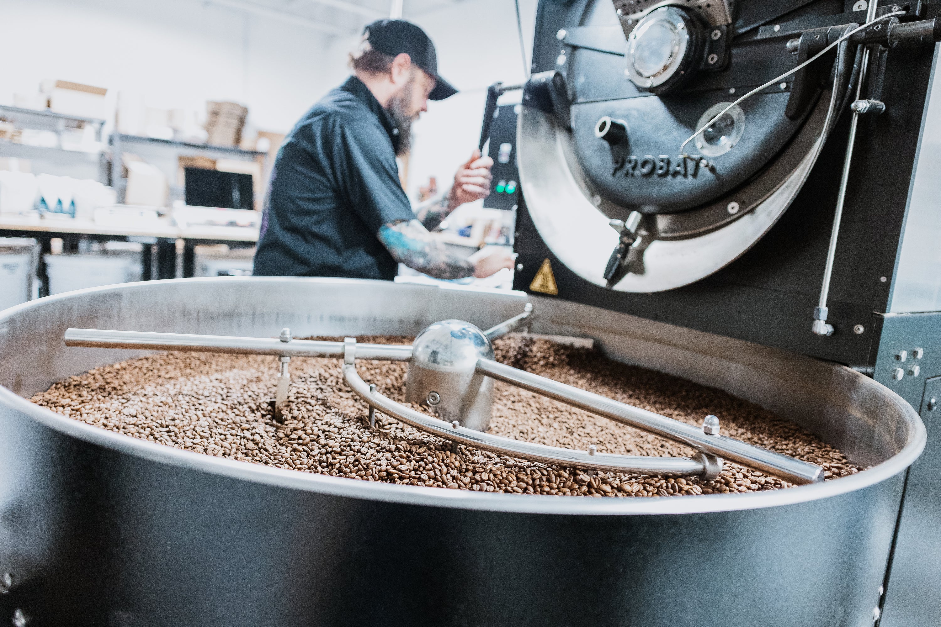 Master Roaster Dennis works the roasting machine at the Coffee Roasting Lab