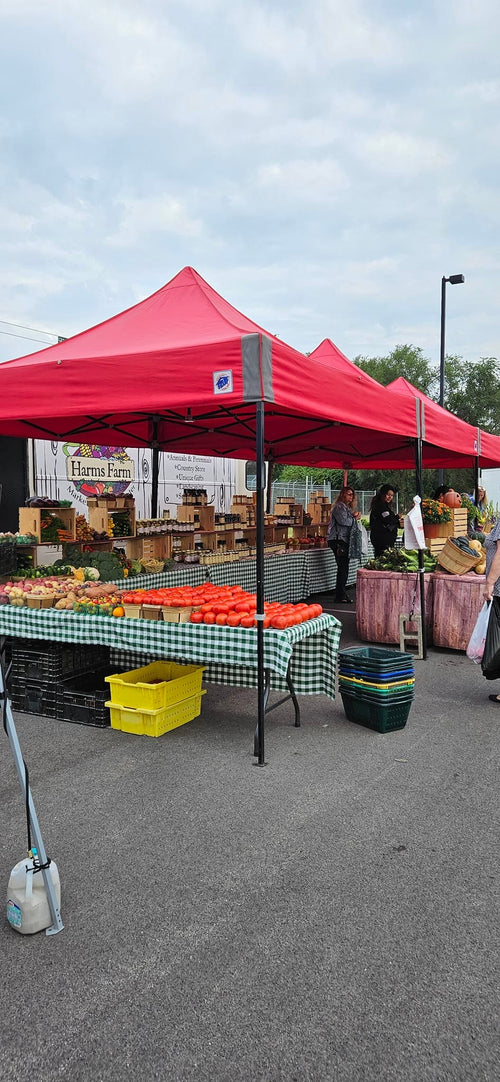 A tent with produce at the Cary Farmer's Market