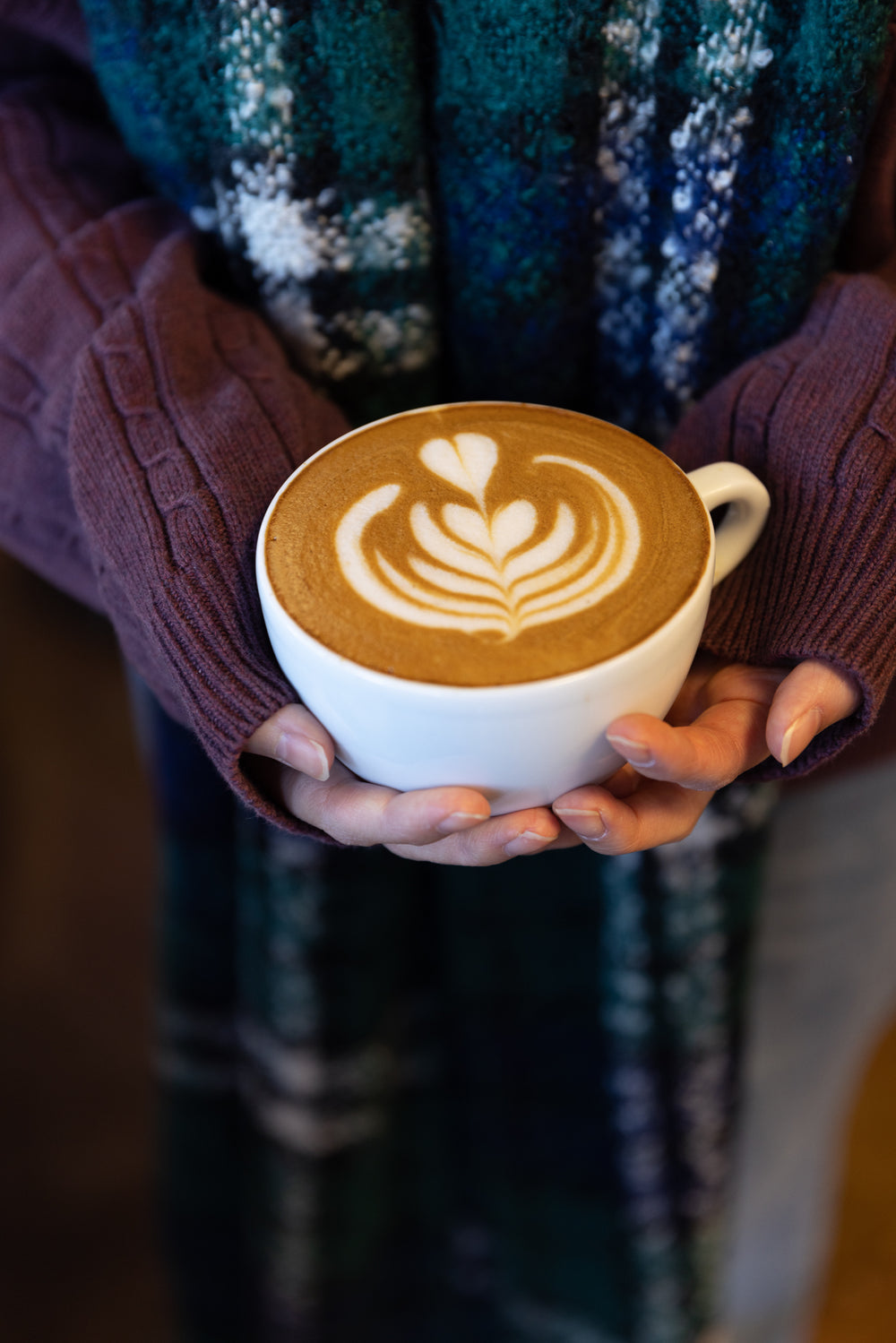 girl holds her coffee cup